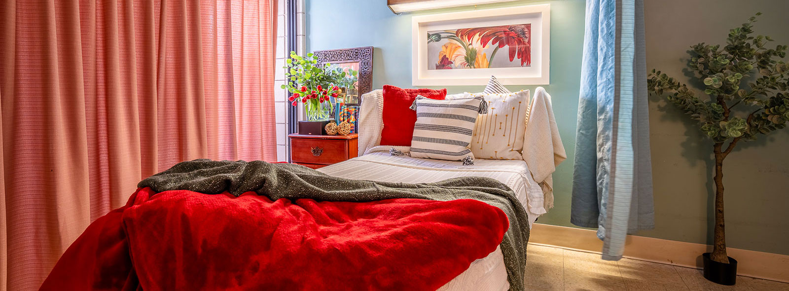Bed with red blankets at Alhambra
